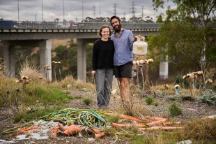 Young man and woman in garbage dump finding materials for design projects. Pit Projects.
