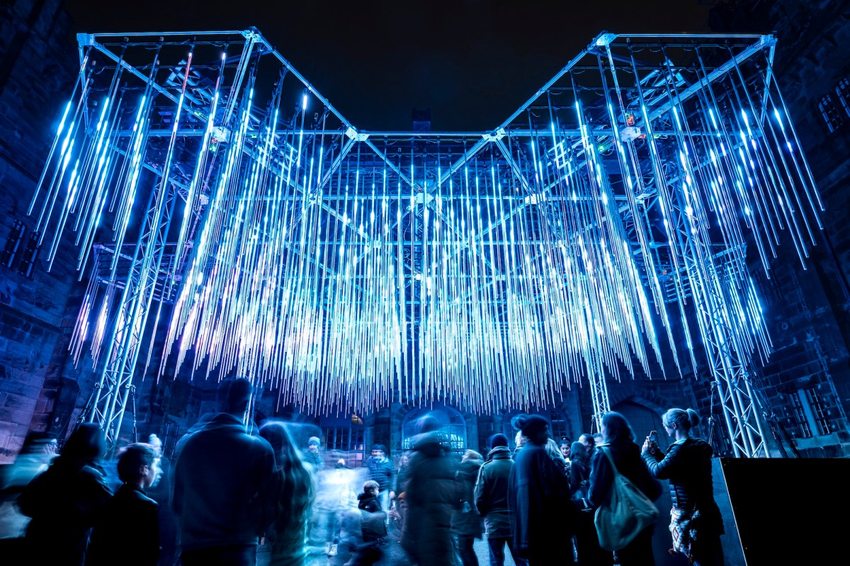 Outdoor light installation at night of hanging blue illuminated rods. Illuminate Adelaide