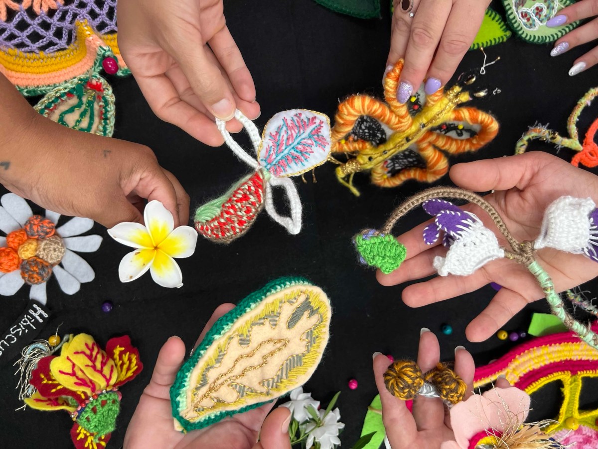 overhead image of hands holding hand made textile objects. Cul Collective.