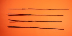 Four tribal spears on orange background. Chau Chak Wing Museum