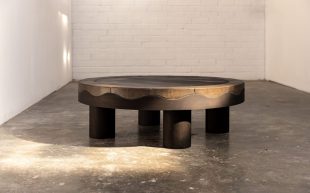 A low round table made out of Hydrowood myrtle, stoneware tiles, glaze, igneous rocks, sandstone, industrial waste inside a white industrial gallery space. Design Tasmania.