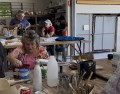 three people working and chatting in a ceramic studio. North Queensland Potters