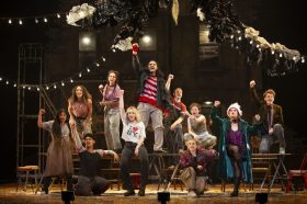 2024 cast of Rent musical sing and pose on stage during theatre performance.