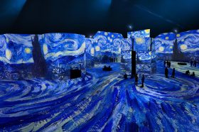 Van Gogh's The Starry Night displayed across the walls and floors of the LUME.
