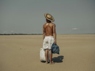 A finalist for the World Press Photo, Musuk Nolte's portrait shows a farmer carrying food across an Amazonian dried river bed. Image: Musuk Nolte.