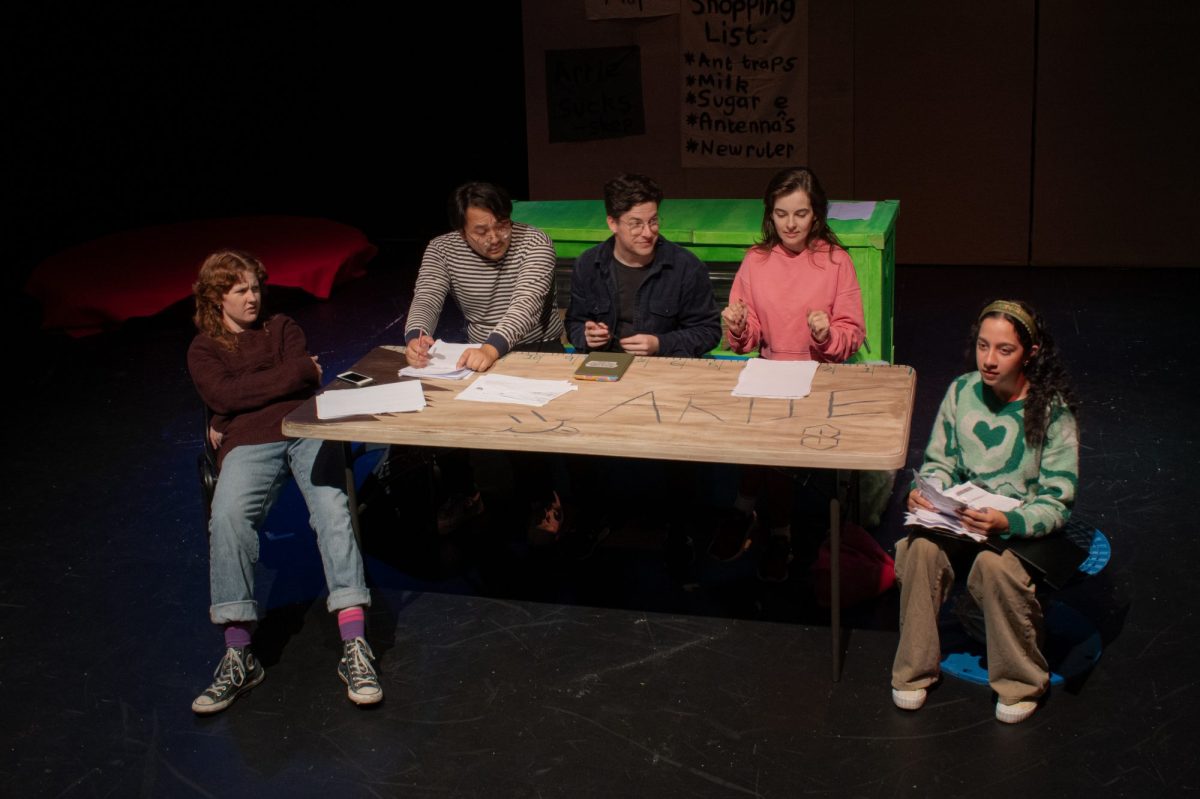A group of young adults are sitting at a table.