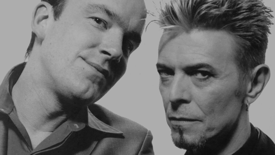 A black and white photo of two men, the comedian Jack Docherty and David Bowie.