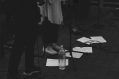 Singer's and musician's feet standing in front of sheet music and microphones.