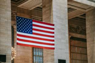 US arts policy change: an American flag flying in front of a stately building.