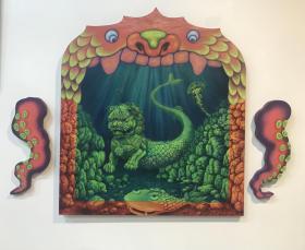 A Chinese lion, transformed into some form of mermaid, is framed like an old-fashioned theatre stage. The pieces on either side, completing the three-panel work, are octopus tentacles. The artwork by Ruby Li is showing as part of the Asian Heritage Week Exhibition at Dark Horse Experiment.