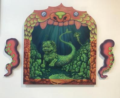 A Chinese lion, transformed into some form of mermaid, is framed like an old-fashioned theatre stage. The pieces on either side, completing the three-panel work, are octopus tentacles. The artwork by Ruby Li is showing as part of the Asian Heritage Week Exhibition at Dark Horse Experiment.