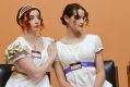 Two women in white Regency-style dresses. A promotional image for the production 'Austen in Therapy'.