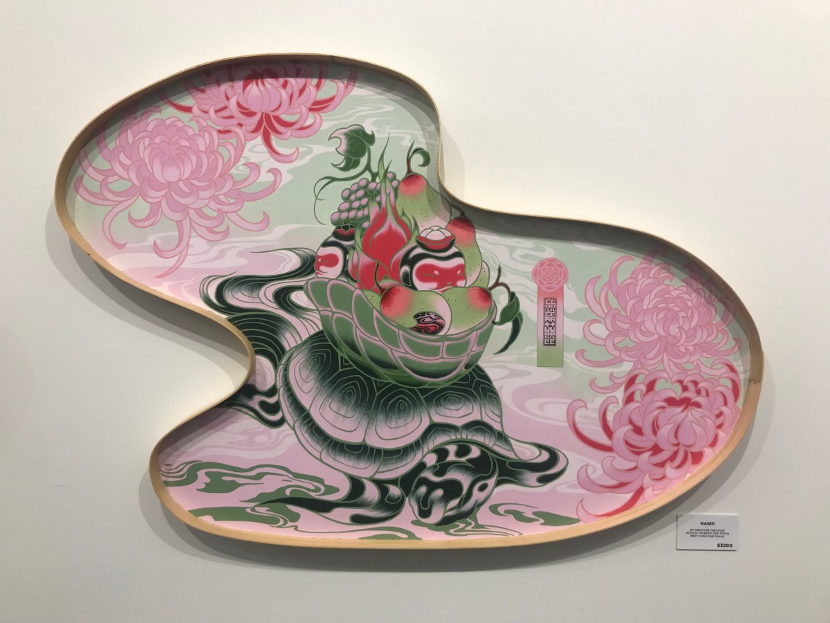 A swirly globule-shape painting in shades of pink featuring a turtle. The artwork is part of the joint exhibition Masakatsu Sashie and Creature Creature: Auspicious Delicious, currently showing at Melbourne's Outré Gallery.
