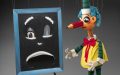 Mr Squiggle, puppet with a pencil as a nose, and a black board with a sad expression.