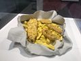 A large sculpture of fish and chips in white paper wrapping.