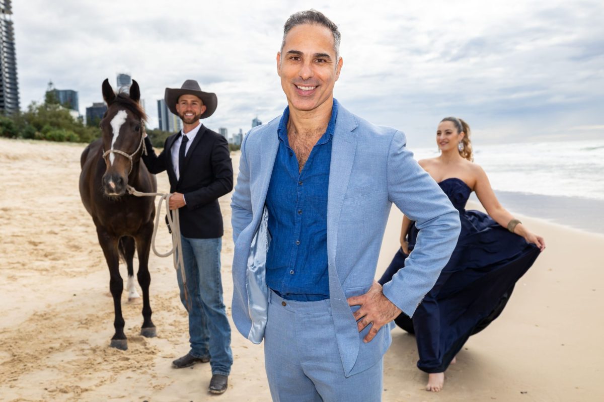 Under Michael Zavros' curatorial eye, BLEACH* Festival arrives at the Gold Coast later this year. Three people and a horse stand on a Gold Coast beach, smiling at the camera.