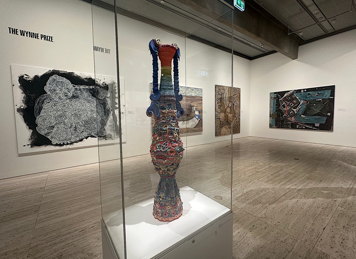 View of gallery exhibition with large ceramic sculpture in glass case. Wynne Prize.