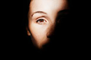 Photo of a person with light shining on her one eye.