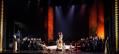 Large stage scene of 'Samson & Delilah'. In the centre are figures wearing gold costumes. They are surrounded by cast in black.