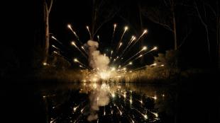 An explosion: bright yellow sparks in the dark.
