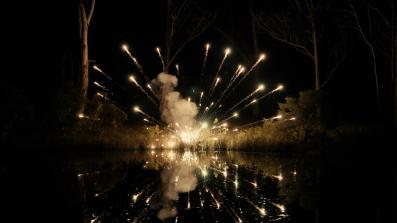An explosion: bright yellow sparks in the dark.