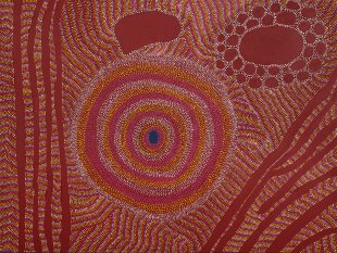 Aboriginal artwork that's earthy red with dots and swirls.