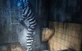 A figure in prison black and white stripes trying to escape.