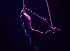 A dark shot of an aerialist female