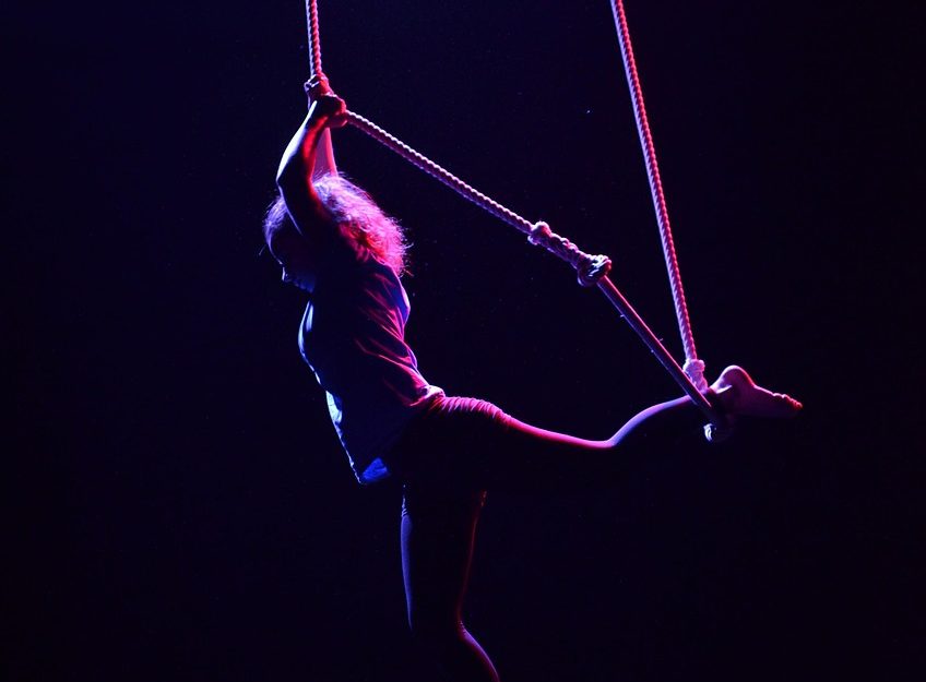 A dark shot of an aerialist female
