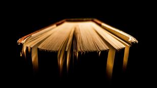 An old book, with its pages splayed out.