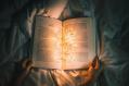 Some fairy lights in the middle of an open book.