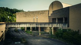 An abaonded shopping mall in pale concrete.