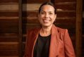 A smiling First Nations woman with a black top and russet jacket, her hair is parted and slicked back. Frances Rings - what I've learned