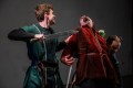 Two men in Shakespearean costume. One has his sword up against the other's throat. Henry 6.