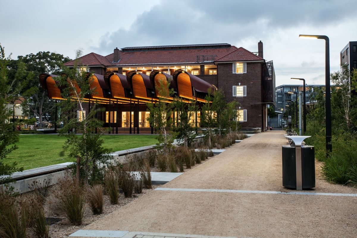 Photo of a red-stone architecture with both contemporary and historic looking elements.