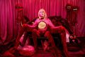 A lavishly set up photograph featuring a red velvet sofa and a figure dressed in a blond wind, cut out red velvet costume where the limbs extend like bug claws. Australian Life Photography Competition finalist Chrissie Hall, ‘The bargain of a life: a couch with legs and no breasts’. Opportunities.