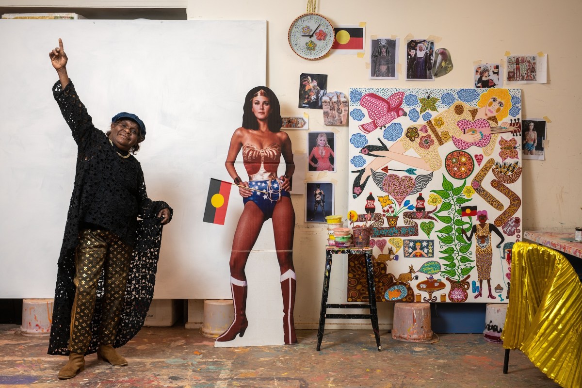 First Nations artist Kaylene Whiskey in her studio with wonder woman.
