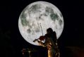 Columbian-Australian violinist Natalya Bing, a Queenstown resident, plays her instrument in front of a seven-metre-diameter reproduction of the moon as part of 'Earthshine' at The Unconformity, 2023.