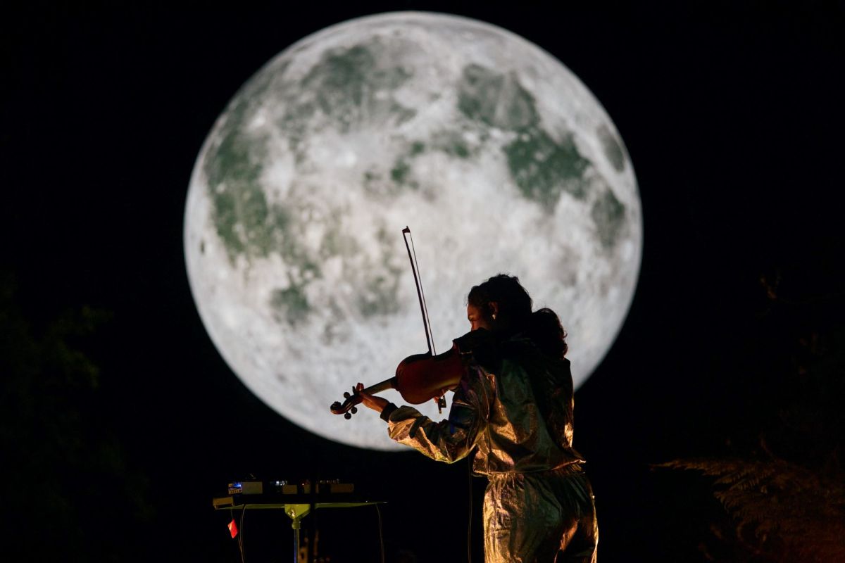 Columbian-Australian violinist Natalya Bing, a Queenstown resident, plays her instrument in front of a seven-metre-diameter reproduction of the moon as part of 'Earthshine' at The Unconformity, 2023.