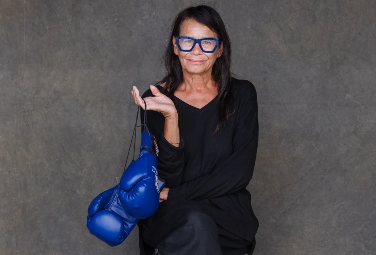 Women in black with blue glasses and holding blue boxing gloves. Rhoda Roberts. NAIDOC