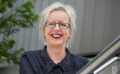 A middle aged woman with short blonde hair and a black shirt. she is smiling. Vale Judith Isherwood.