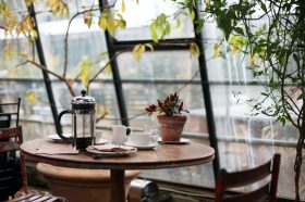 At this death café, a small table is by a large window.