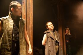 Three women dressed in beige colours in the production of Othello.