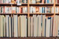 A row of books lined up so you can see their pages. Bakers Lane Books prize.