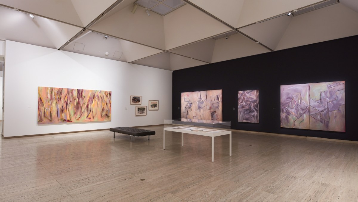 Gallery view with large abstract paintings in oranges and purples. Janet Dawson.