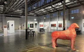 A big warehouse showcasing art, featuring a large sculptural work of what appears to be a four-legged animal. Free exhibitions Western Australia.