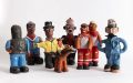 Comical ceramic figures depicting Aboriginal people in different uniforms.