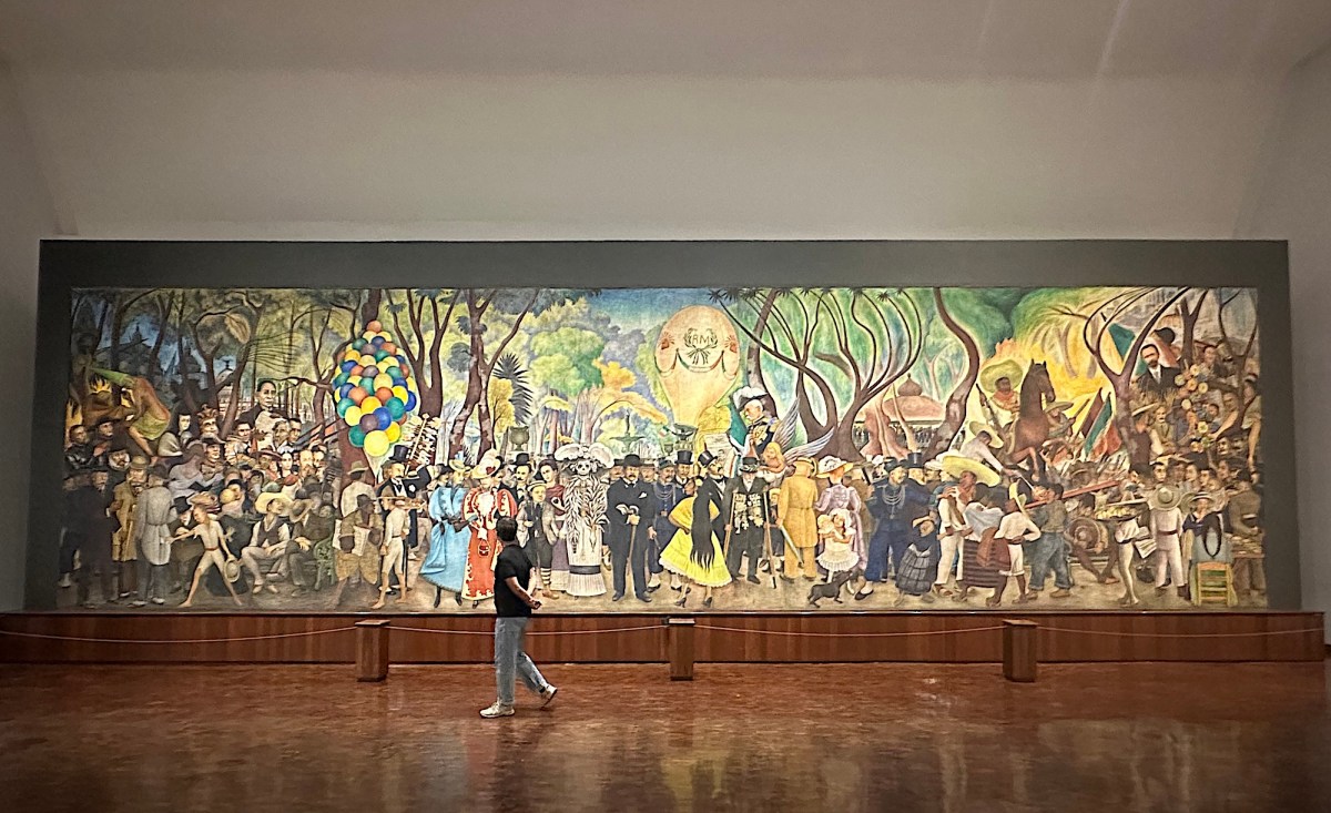view inside a gallery with a very long painting of a sunday park scene. Diego Rivera Mexico City