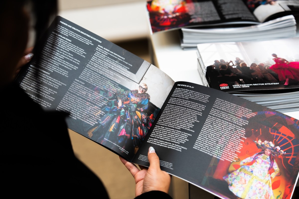 NSW Fashion Sector Strategy - image of a person flipping through an art book of designs.