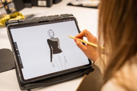 A young woman drawing a fashion design on a tablet. NSW Fashion Strategy